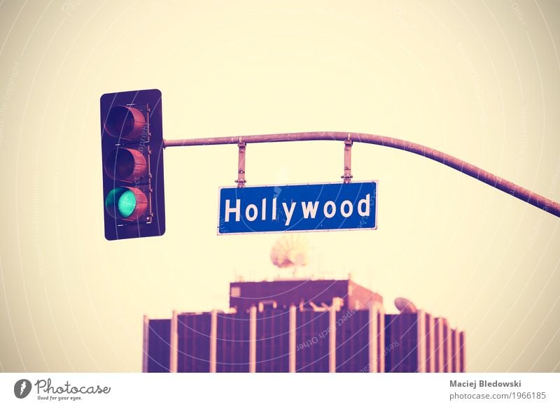 Vintage toned Hollywood street sign and traffic lights. Summer Manmade structures Roof Satellite dish Street Traffic light Road sign Hip & trendy Rich Retro