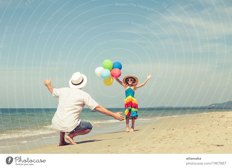 Father and daughter with balloons playing on the beach Lifestyle Joy Relaxation Leisure and hobbies Playing Vacation & Travel Trip Freedom Summer Sun Beach