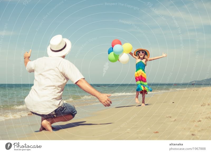 Father and daughter with balloons playing on the beach Lifestyle Joy Relaxation Leisure and hobbies Playing Vacation & Travel Trip Freedom Summer Sun Beach