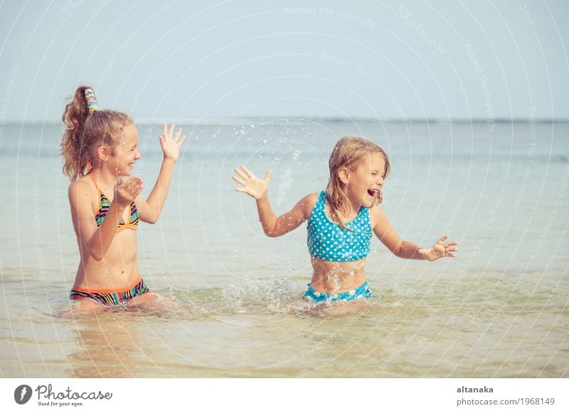 Two happy children playing on the beach Lifestyle Joy Happy Beautiful Relaxation Leisure and hobbies Playing Vacation & Travel Freedom Summer Sun Beach Ocean