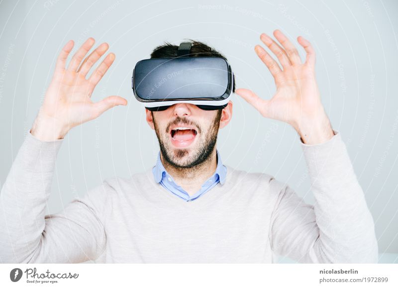 Man with VR glasses scared and raises hands on white background Virtual virtual reality virtual reality simulator Joy Amazed Playing Computer games Expedition