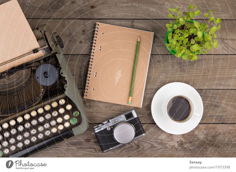 Vintage typewriter on the old wooden desk Coffee Tea Pot Design Desk Table Workplace Office Camera Newspaper Magazine Book Plant Paper Wood Old Write Retro