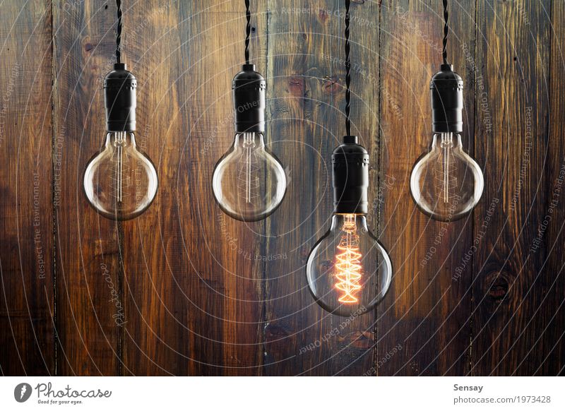 Idea and leadership concept Vintage incandescent bulbs Design Lamp Success Science & Research Technology Wood Old Bright Yellow Red Energy Colour Creativity