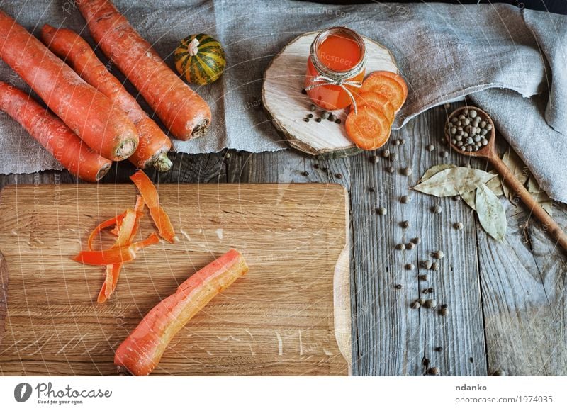 Fresh carrots on the chopping board Vegetable Herbs and spices Nutrition Vegetarian diet Diet Beverage Juice Bottle Glass Spoon Table Wood Old Above Juicy Gray