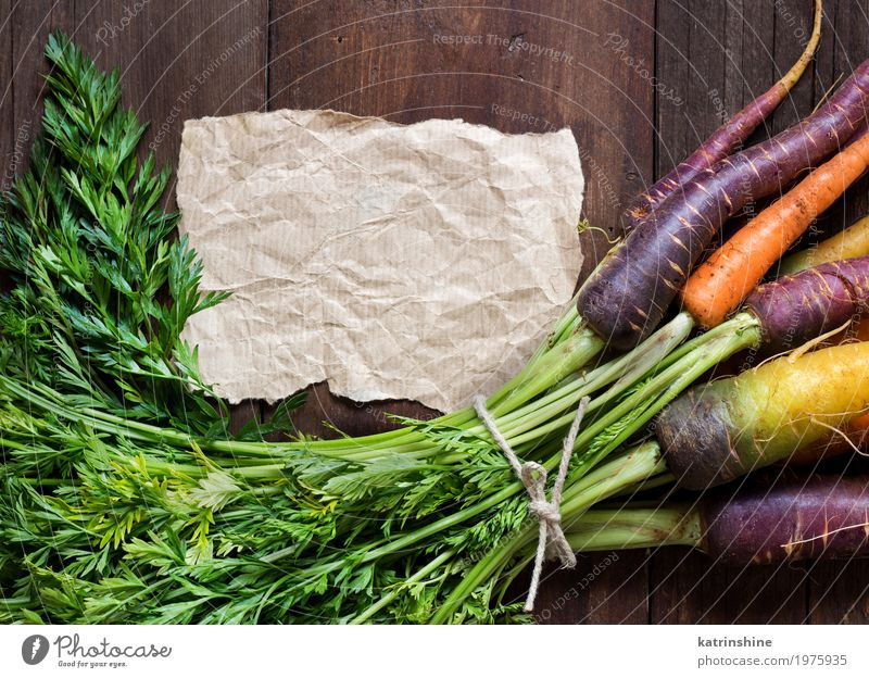 Fresh organic rainbow carrots and craft paper on wood Vegetable Nutrition Vegetarian diet Paper Write Brown Yellow Carrot Farmer food Harvest healthy market