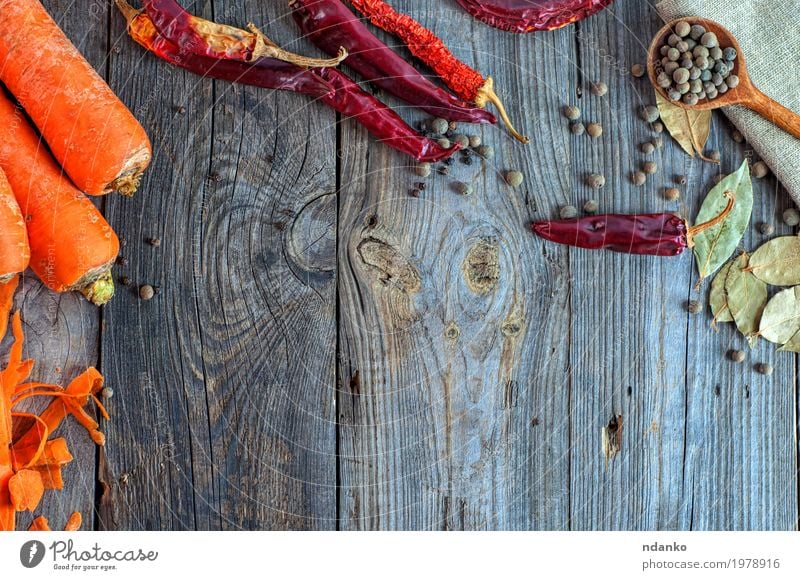 Gray wooden background with raw vegetables and spices Food Vegetable Herbs and spices Nutrition Eating Vegetarian diet Diet Spoon Table Wood Old Fresh Above