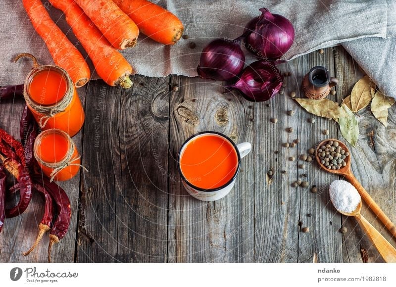 Carrot juice in glass jars and iron mug Food Vegetable Herbs and spices Vegetarian diet Diet Beverage Drinking Hot drink Juice Cup Table Wood Old Fresh Above