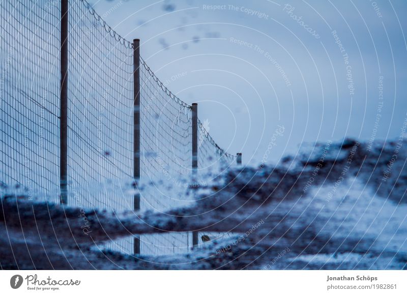 puddle of fence Sky Esthetic Fence Mirror image Reflection Border Boundary Inverted Puddle Wet Water Rain Dreary Blue Gloomy Grief Net Wire mesh Colour photo