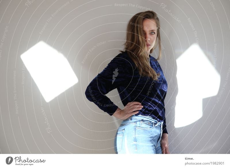 . Room Feminine Young woman Youth (Young adults) 1 Human being Jeans Sweater Blonde Long-haired Patch of light Observe To hold on Looking Stand Beautiful