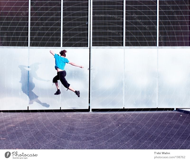 Now I'm jumping Joy Leisure and hobbies Human being Young man Youth (Young adults) 1 Gate Street Jump Free Thin Athletic Blue Tunnel entrance Grating Tall