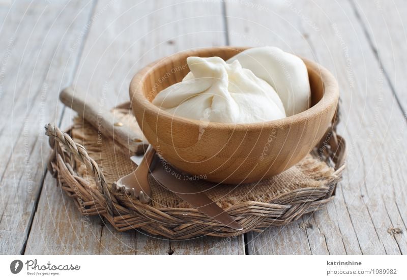 Italian cheese burrata with bread on a wooden background Cheese Nutrition Vegetarian diet Italian Food Bowl Knives Fork Wood Fresh Delicious Soft White