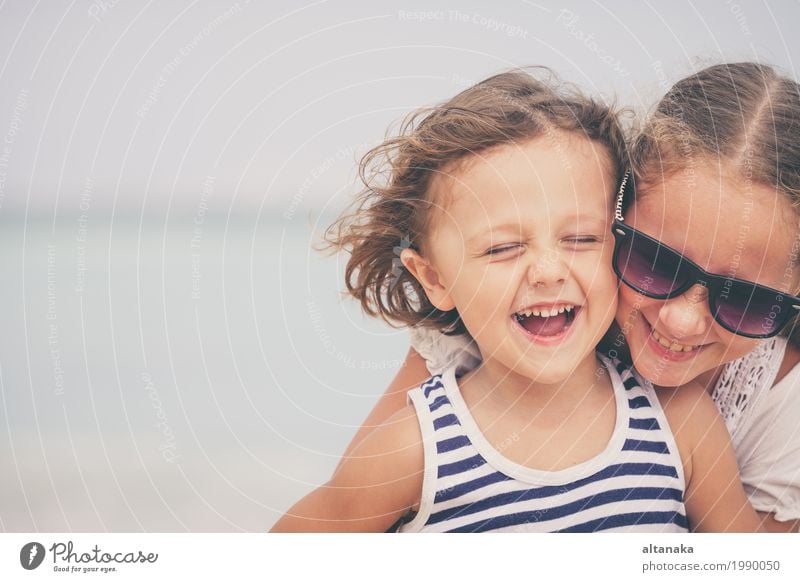 Sister and brother playing on the beach at the day time. Lifestyle Joy Happy Beautiful Relaxation Leisure and hobbies Playing Vacation & Travel Freedom Summer