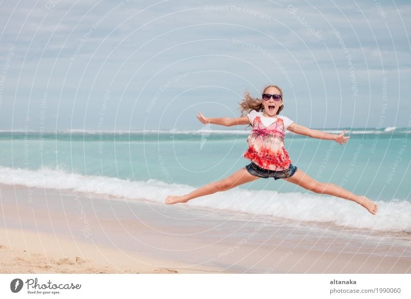Happy teen girl jumping on the beach Lifestyle Joy Leisure and hobbies Playing Vacation & Travel Trip Freedom Summer Sun Beach Ocean Sports Child Girl Woman