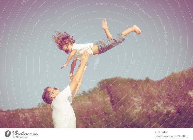 Father and son playing on the beach at the day time. Concept of friendly family. Lifestyle Joy Relaxation Leisure and hobbies Playing Vacation & Travel Trip