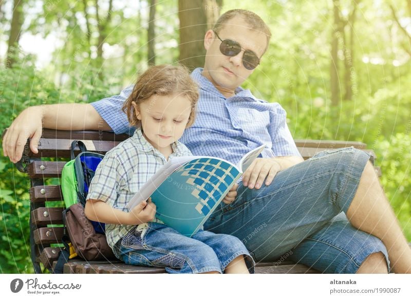 Father and son playing at the park on bench at the day time. Lifestyle Joy Relaxation Leisure and hobbies Playing Reading Vacation & Travel Freedom Summer Sun