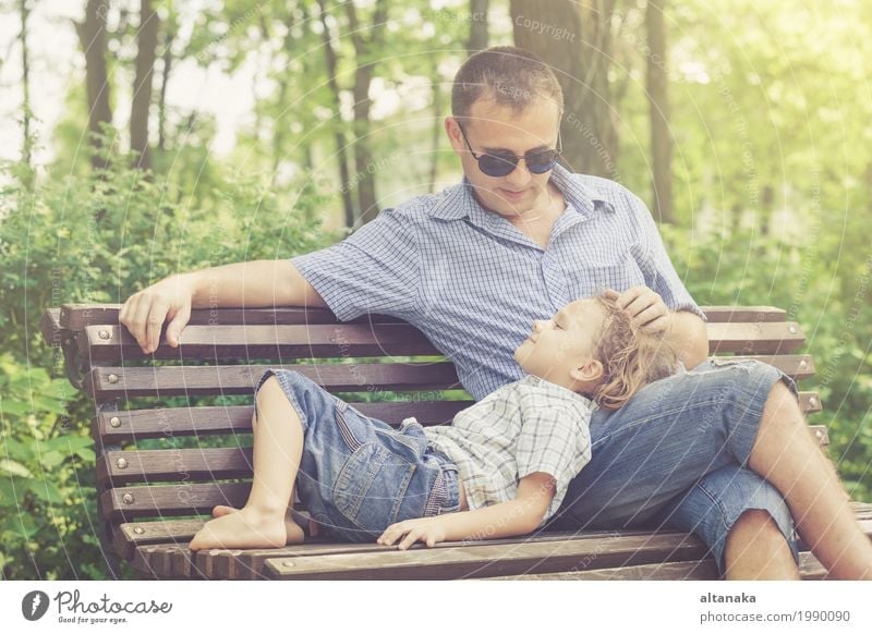 Father and son playing at the park on bench at the day time. Lifestyle Joy Happy Leisure and hobbies Playing Vacation & Travel Freedom Summer Sun Child School