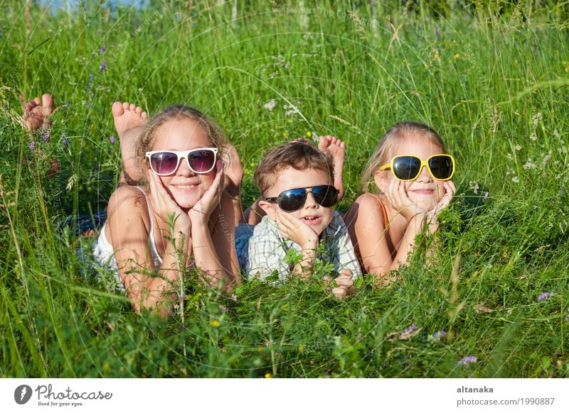 Three happy children playing in the park at the day time. Lifestyle Joy Happy Beautiful Face Leisure and hobbies Playing Vacation & Travel Freedom Summer Child