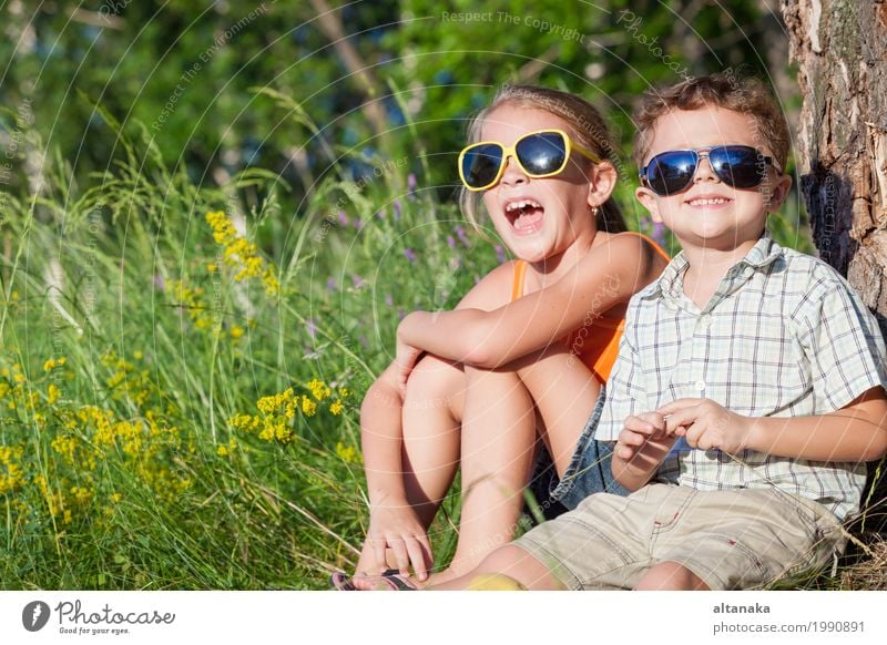 Two happy children playing near the tree at the day time. Lifestyle Joy Happy Beautiful Face Leisure and hobbies Playing Vacation & Travel Freedom Summer Child