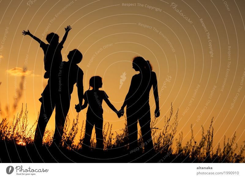 Happy family standing in the park at the sunset time. Lifestyle Joy Beautiful Leisure and hobbies Playing Vacation & Travel Trip Freedom Summer Sun Child Girl