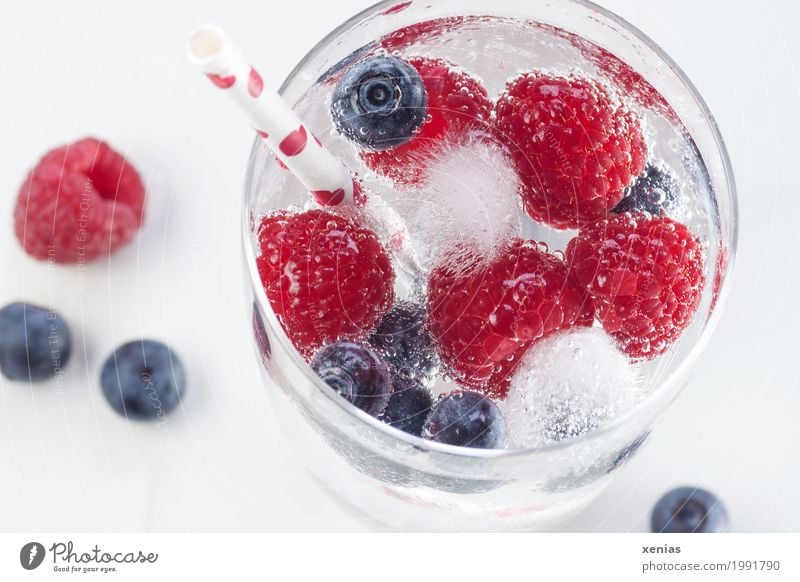 Refreshing drink with raspberries and blueberries Fruit Raspberry Beverage Cold drink Drinking water Lemonade Ice cube Glass Straw Summer Summer vacation Party