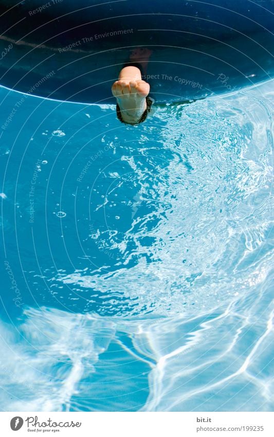 Naked foot hangs alone in the blue water under a swimming tire, in the swimming pool, in summer on vacation. Joy Well-being Contentment Swimming & Bathing