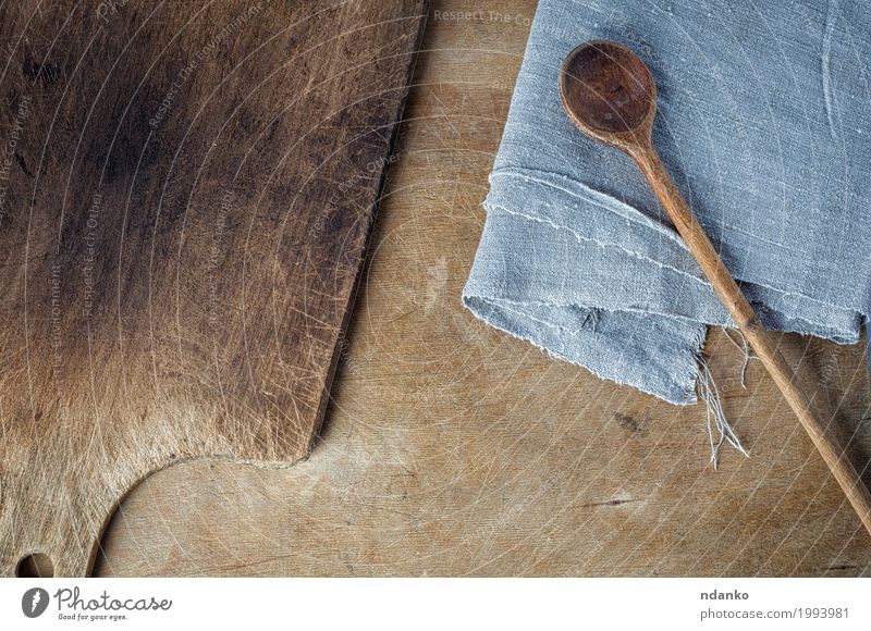 cutting board and a wooden spoon on the table Spoon Table Kitchen Wooden spoon Old Above Brown Gray cook empty space background Shabby housewares Home textile