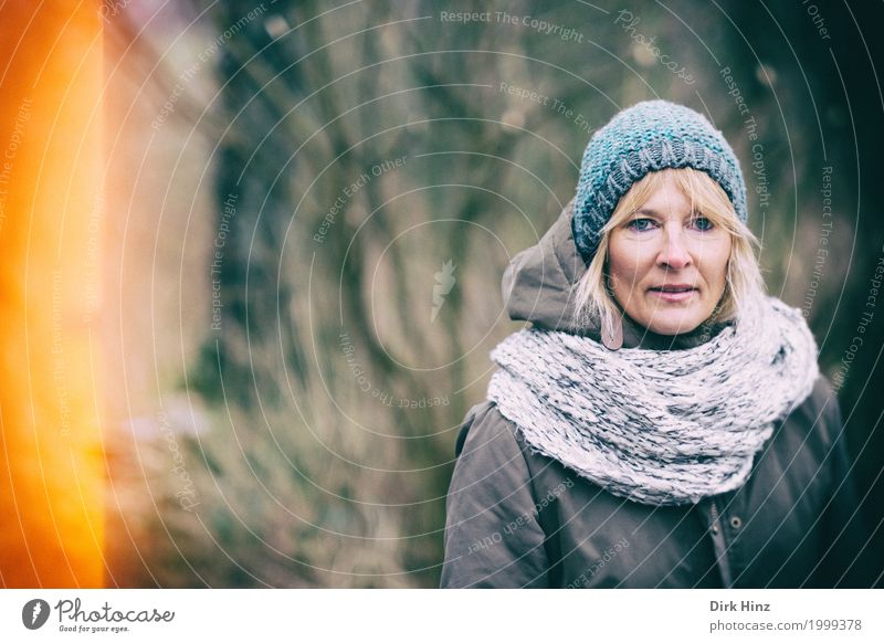 Woman with cap in cold season Feminine Mother Adults 1 Human being 45 - 60 years Blonde peel Winter Autumn Autumnal Shaft of light Face of a woman Looking