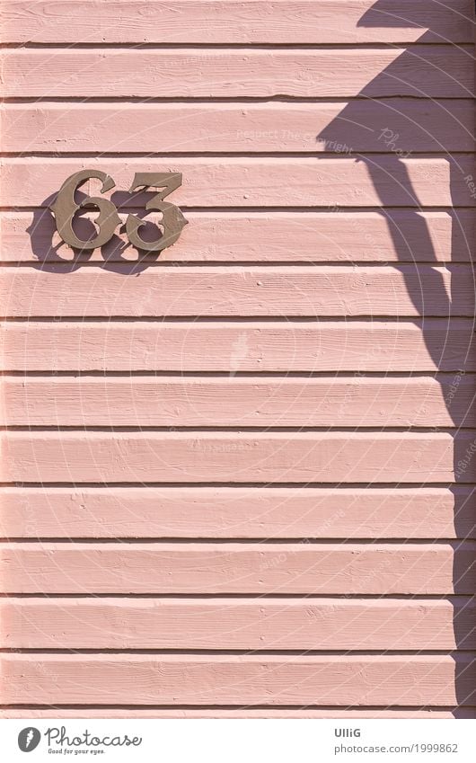 House number 63 on a pink board wall. House (Residential Structure) Architecture Wall (barrier) Wall (building) Digits and numbers Pink gnothimage Panels