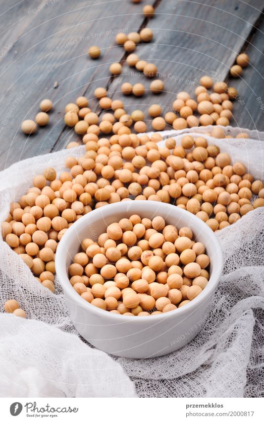 Soy beans in a bowl on wooden table Grain Nutrition Organic produce Vegetarian diet Bowl Wood Fresh Natural Beans Fiber food healthy Ingredients Protein Raw
