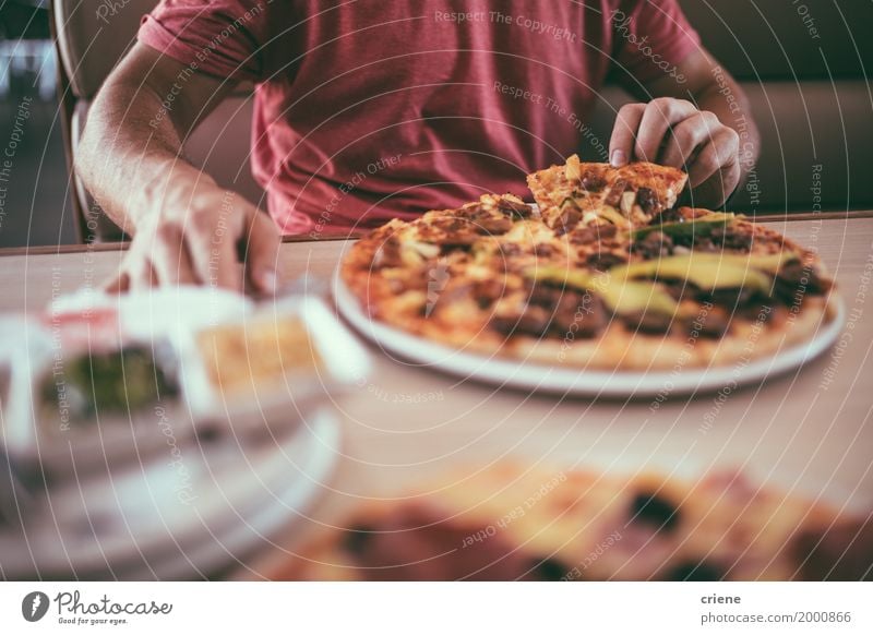 Close-up of man eating delicious pizza for lunch in restaurant Food Dough Baked goods Eating Lunch Dinner Fast food Finger food Crockery Plate Lifestyle Table