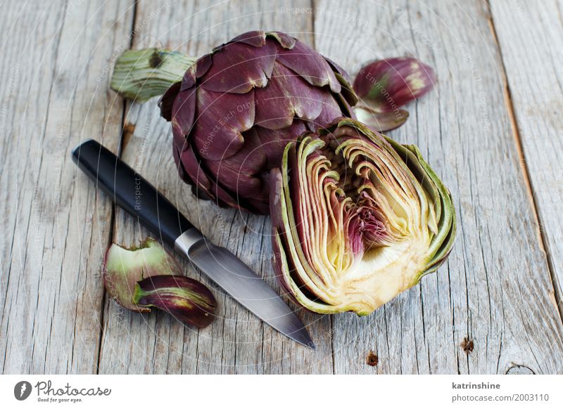 Roman Artichokes on a wooden board with knife Vegetable Nutrition Vegetarian diet Italian Food Knives Fresh Gray Green agriculture Purple cooking Cut Edible