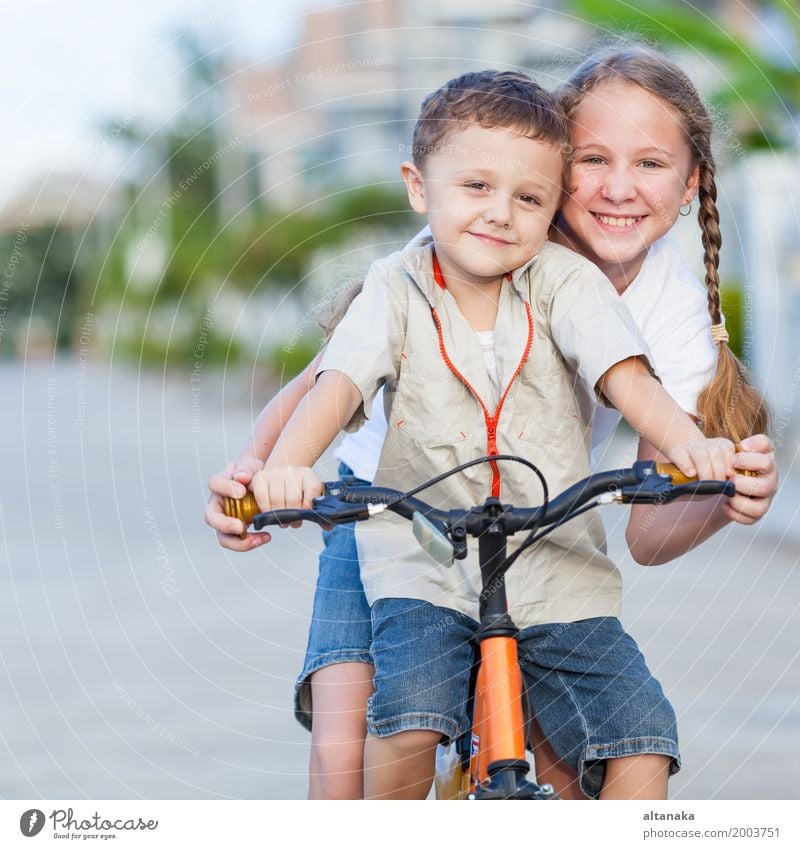 Happy kids with bike standing on the road at the day time. Lifestyle Joy Leisure and hobbies Playing Summer Child School Human being Girl Boy (child) Sister