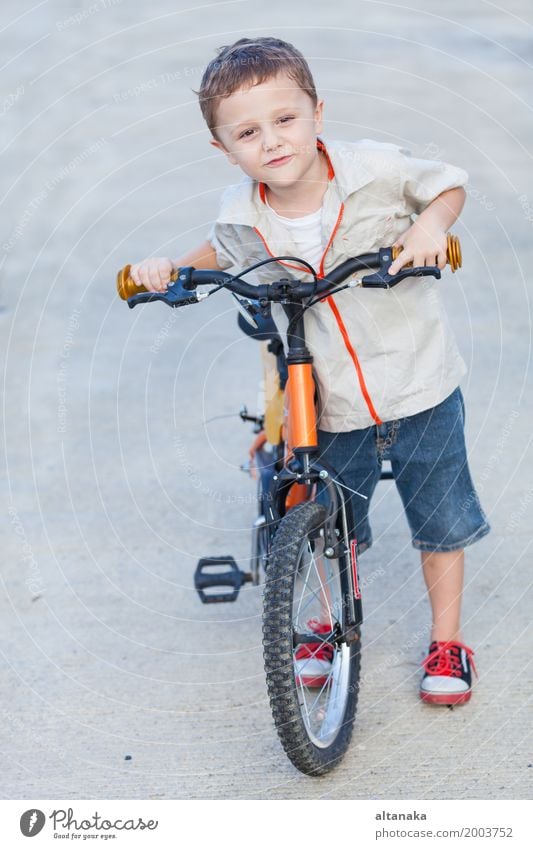 Happy Little Boy Riding a Bike Stock Image - Image of lifestyle