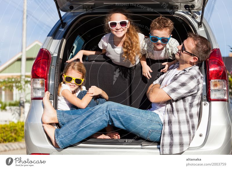 Happy family getting ready for road trip on a sunny day. Concept of friendly family. Lifestyle Joy Leisure and hobbies Vacation & Travel Trip Adventure Freedom