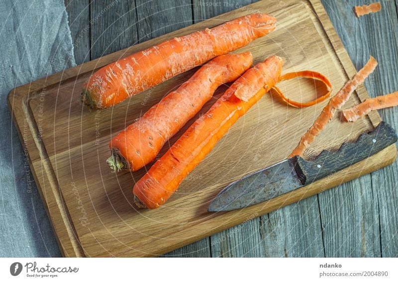 Whole carrots on a kitchen cutting board Vegetable Nutrition Eating Vegetarian diet Diet Table Wood Fresh Above Produce Vegan diet agriculture Organic orange