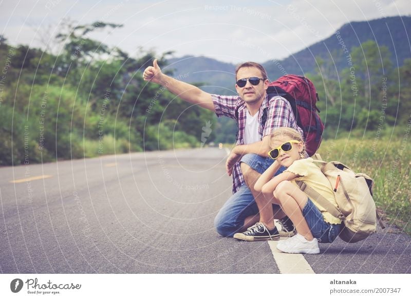Father and daughter walking on the road at the day time. Lifestyle Joy Happy Leisure and hobbies Vacation & Travel Trip Adventure Freedom Summer Mountain Hiking