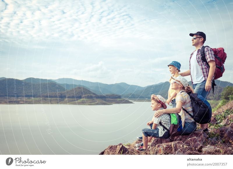 Happy family standing near the lake at the day time. Concept of friendly family. Lifestyle Joy Leisure and hobbies Vacation & Travel Trip Adventure Freedom