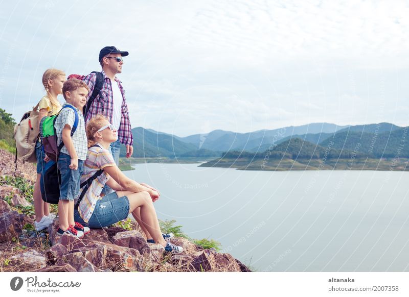 Happy family standing near the lake at the day time. Healthy Hiking Human being Child Woman Adults Man Parents Mother Father Brother Sister Friendship Smiling
