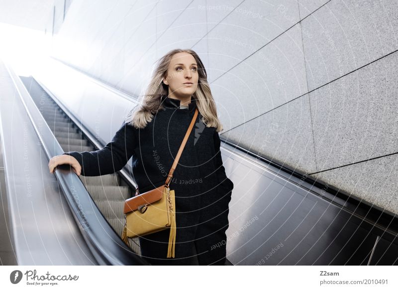 Woman on escalator Lifestyle Elegant Style Adults 18 - 30 years Youth (Young adults) Town Fashion Coat Bag Blonde Long-haired Think Driving smile Dream luck