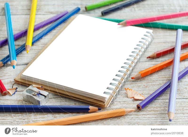 Drawing-pad and color pencils on a wooden table - a Royalty Free