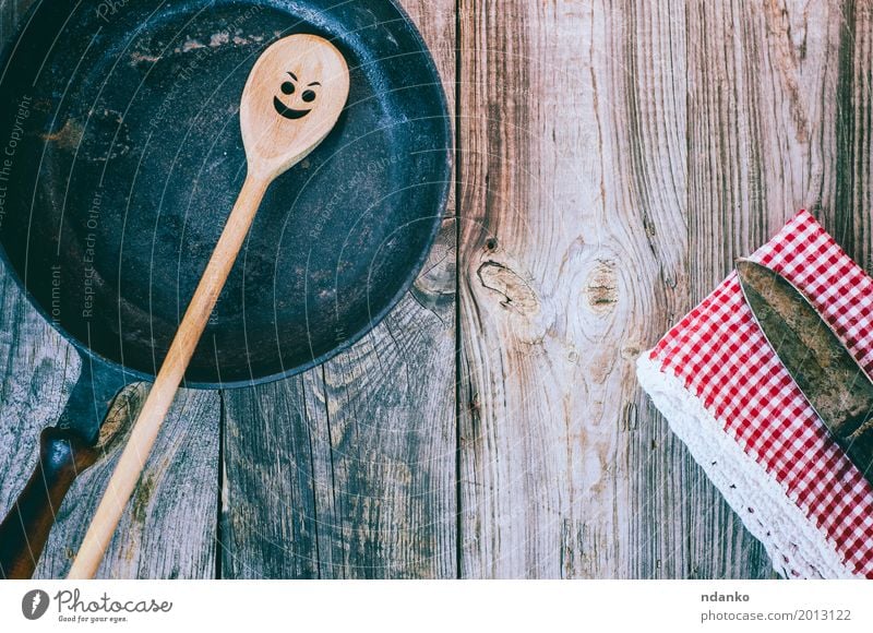 Vintage black frying pan with a wooden spoon Crockery Pan Spoon Table Kitchen Restaurant Cloth Wood Metal Old Above Clean Red Black Emotions tableware