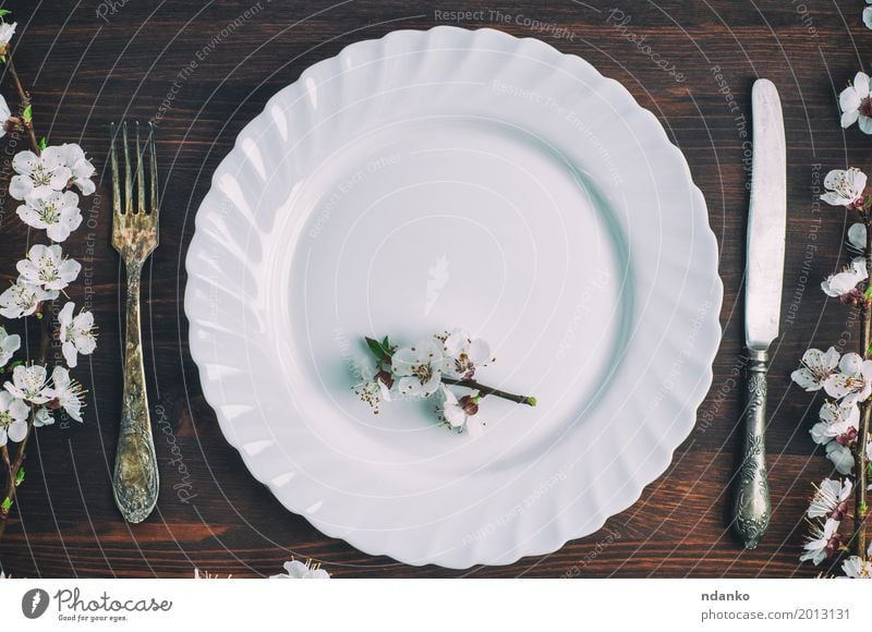 White plate with a fork and knife on a brown wooden surface Lunch Dinner Plate Cutlery Knives Fork Table Kitchen Restaurant Flower Places Wood Metal Old Eating