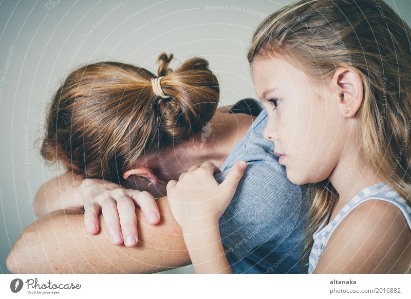 mother and daughter hugging sad