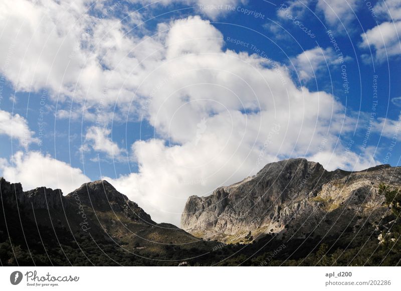under the clouds Environment Nature Landscape Air Sky Clouds Spring Climate Weather Beautiful weather Rock Alps Mountain Peak Authentic Blue White Power Majorca