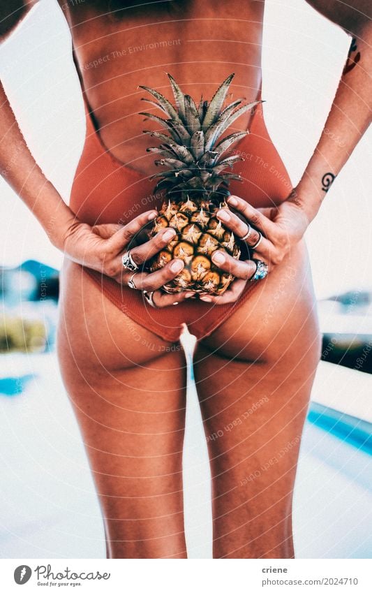 Attractive female adult holding pineapple behind her back Fruit Lifestyle Joy Body Swimming pool Vacation & Travel Tourism Summer Summer vacation Sun Sunbathing
