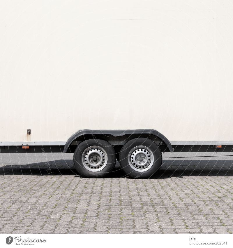 On the road Parking lot Trailer Wheel Tire Gray Black White Colour photo Exterior shot Copy Space top Day