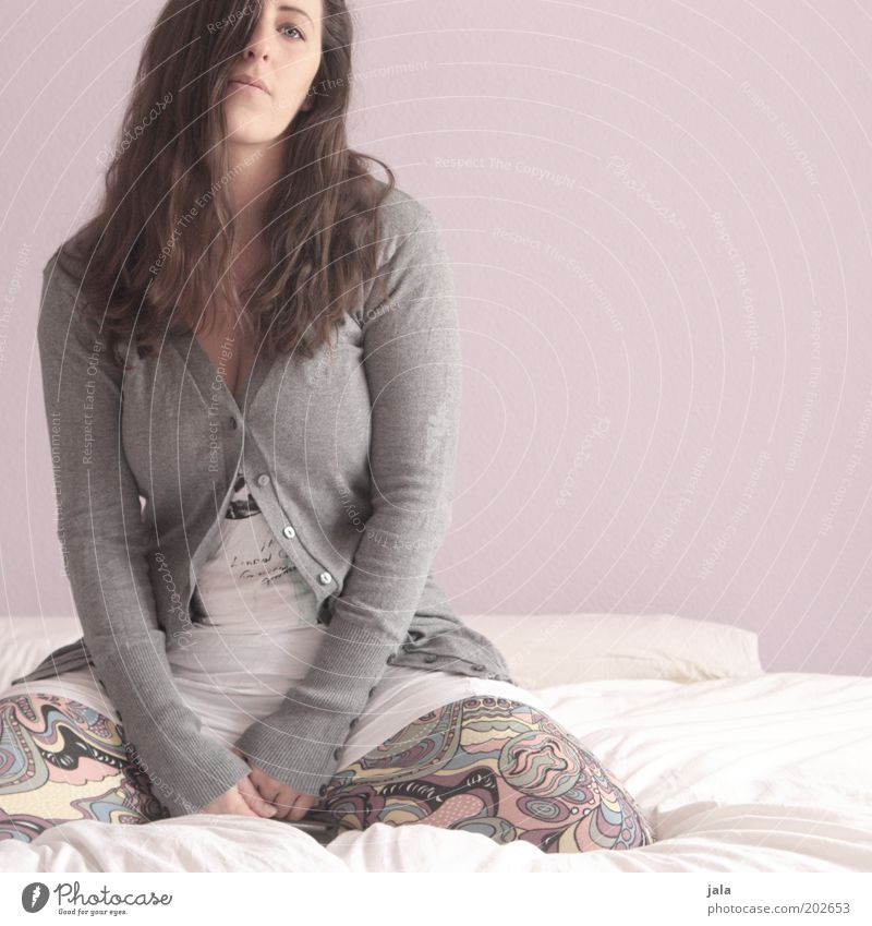 So what? Human being Feminine Woman Adults 1 Clothing Brunette Sit Boredom Colour photo Interior shot Copy Space right Day Forward Young woman Bed Gray Cardigan