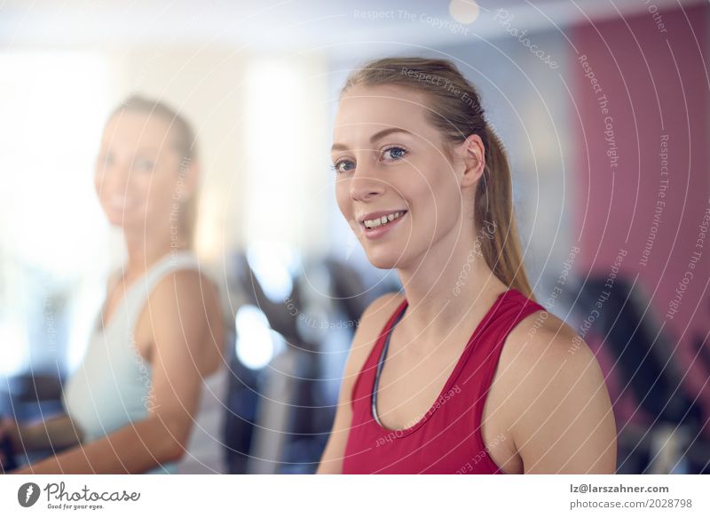 Attractive Woman on treadmill in the gym Lifestyle Happy Beautiful Face Leisure and hobbies Sports Adults 2 Human being 18 - 30 years Youth (Young adults)