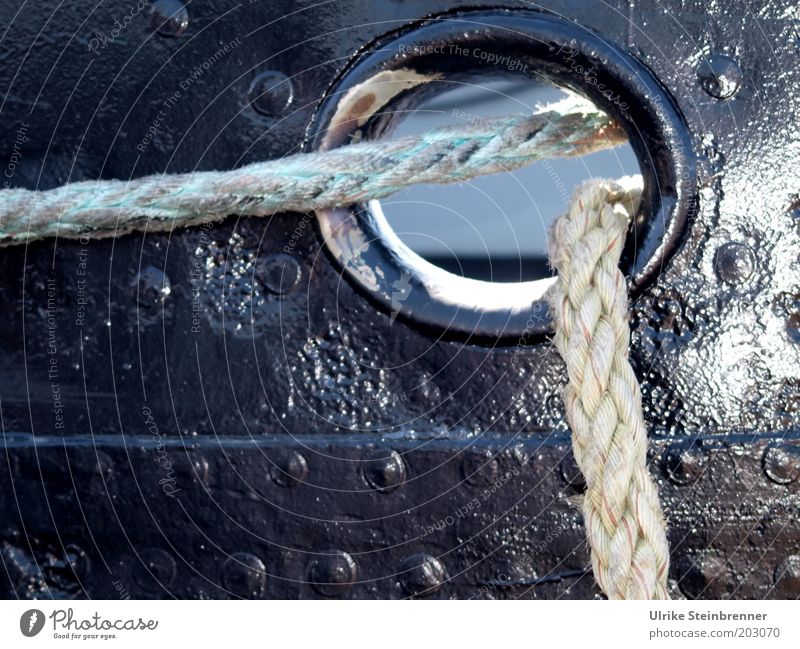 Ropes run through opening in the ship's wall Hollow Watercraft Railing Ship's side Black Plaited String Rivet Hawser Tug Varnish Anticorrosion paint Sun