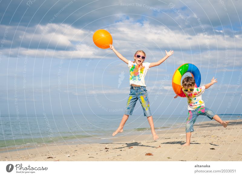 Happy children playing on the beach Lifestyle Joy Beautiful Relaxation Leisure and hobbies Playing Vacation & Travel Adventure Freedom Summer Sun Beach Ocean
